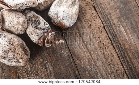 Dried persimmon fruits on wooden background. Oriental sweets
