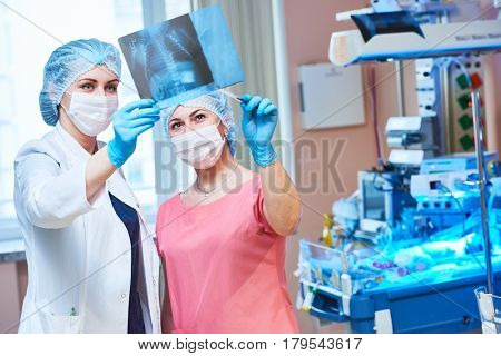 female doctors in front of intensive care unit for newborn baby
