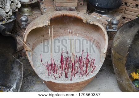 Burning incense at joss stick pot or thurible for respect and pray buddha or god at temple Thailand.