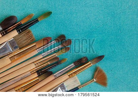 Lots Of Paintbrushes On Colorful Canvas Background