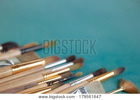Lots Of Paintbrushes On Colorful Canvas Background