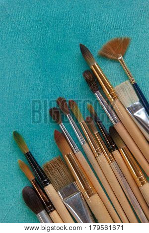 Lots Of Paintbrushes On Colorful Canvas Background