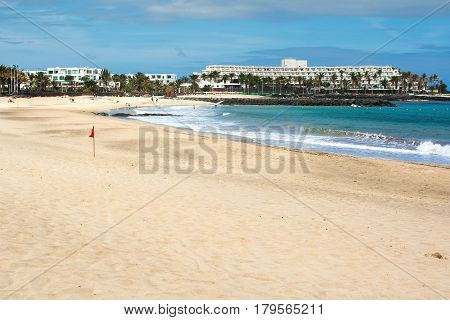 Golden sands and blue sea Playa de las Cucharas beach in Costa Teguise Lanzarote Spain view of the beach and sea selective focus