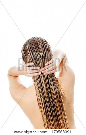 Photo of woman applying hair conditioner.