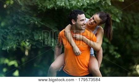 Happy sporty couple hacing fun after jogging in nature
