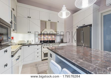 Kitchen Interior with Island Sink CabinetsTiled Floors in New Luxury Home