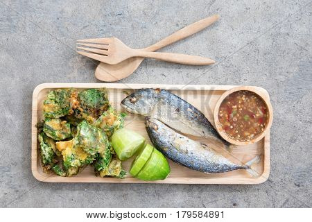 Thai local popular food as spicy shrimp paste dip (Nam Prik Kapi in Thai) served with fried mackerels sliced cucumber and fried acacia pennata omelet