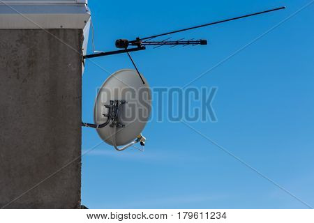Satellite and terrestrial antennas fixed to wall