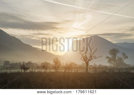 Stunning Winter Foggy Sunrise Over Countryside Around Crummock Water In Lake District England