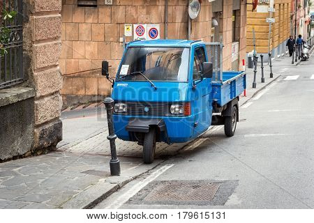 SANTA MARGHERITA LIGURE - DECEMBER 2016: Traditional Italian three wheel car Piaggio Ape staying parked on the street.
