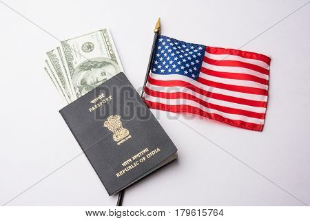 concept showing Indian passport with US currency notes or Dollars with american flag in the background, applying for US / american tourist or H-1B visa