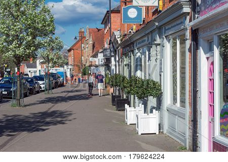 Hartley Wintney, UK. 2nd April 2017. Springtime on a Sunday afternoon in Hartley Wintney high street. Shops and retail establishments are open.