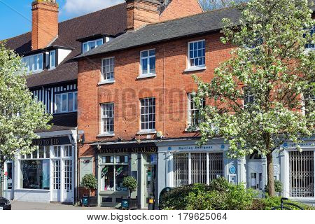 Hartley Wintney, UK. 2nd April 2017. Springtime on a Sunday afternoon in Hartley Wintney high street. Shops and retail establishments are open.