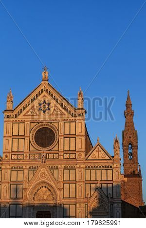 Santa Croce church Florence marble facade over light blue sky background.