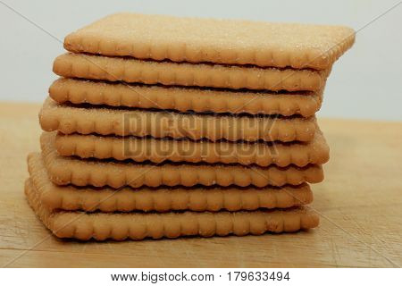 Stacked plain bisuits on a wooden cutting board