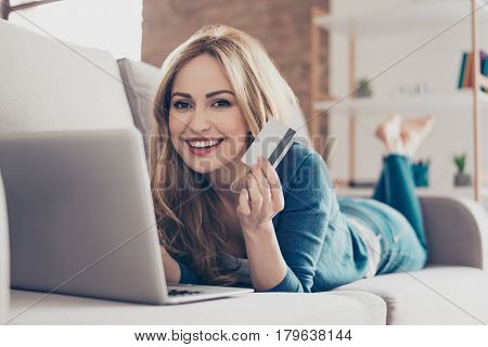 Happy Young Cute Pretty Woman Showing Credit Card And Doing Internet Shopping