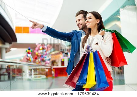 It's Shopping And Fun  Time. Cheerful  Successful Happy Young Lovely Couple In Jacket Holding  Color