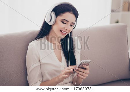 Close Up Portrait Of Beautiful Happy Smiling Woman Listening To Music In Headphones Holding Her Smar