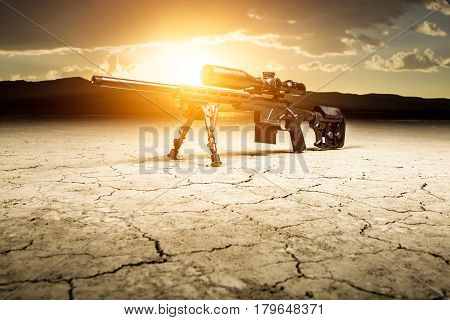 Rifle In The Desert With The Background Of The Sun