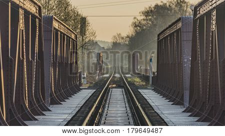 Railway track and bridge in Bakov nad Jizerou area with sunrise
