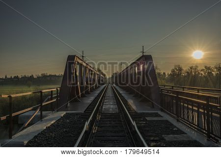 Railway track and bridge in Bakov nad Jizerou area with sunrise