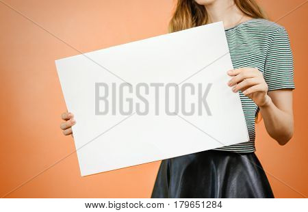 Woman showing blank white big A2 paper. Leaflet presentation. Pamphlet hold hands. Girl show clear offset paper. Sheet template. Booklet design sheet display read first person