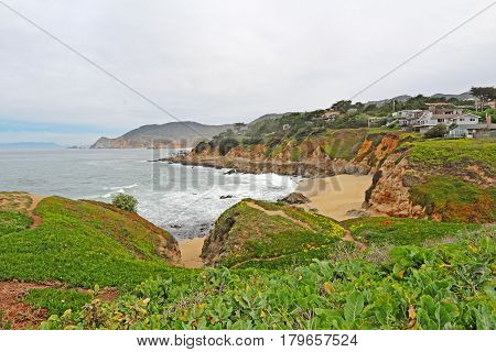 MONTARA CALIFORNIA - MARCH 16 2015: Houses on cliffs overlooking Montara State Beach off of California Highway 1 approximately 25 miles south of San Francisco on a cloudy day.