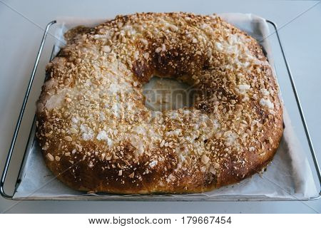 Close Up Of of sweet bread ringed dessert with sugar and almonds. On oven plate Called roscon is typical in spanish cuisine. Horizontal composition