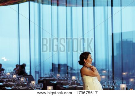 Pregnant Bride Holds Her Nack Daydreaming In An Empty Cafe