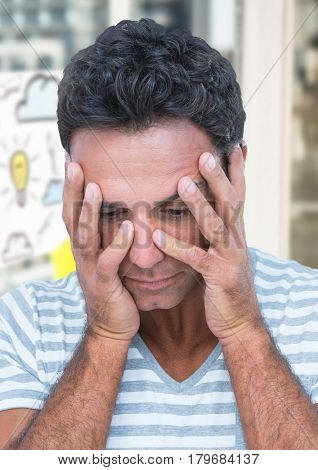 Digital composite of Upset man against lightbulb cloud drawings and windows