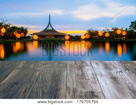 vintage wood terrace with view of Royal garden Rama IX or Suan Luang Rama IX Public Park BangkokThailand at night beautiful sunset color tone effect.
