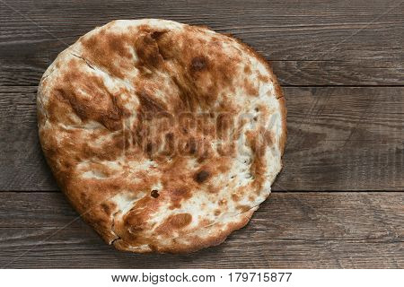 Traditional asian bread. Flatbread on wooden background