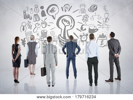 Digital composite of Business people group looking at business graphic drawings