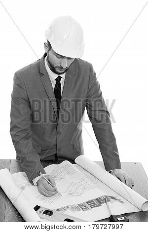 Architect on duty. Monochrome studio shot of a professional constructionist wearing protective hardhat working on a building project isolated on white professionalism experience success development