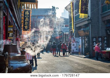 Tianjin, China - Nov 1, 2016: Tianjin Ancient Cultural Street, preserved in the classical Qing Dynasty architectural style. Steam emanating from an urn. Morning scene to what is a very popular tourist area.