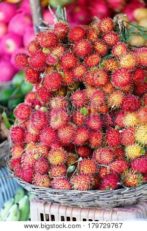 Assortment of fresh exotic rambutan fruits on market stall