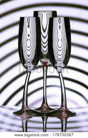 Glasses with reflection of lines. Refraction of lines. Water. Lens effect
