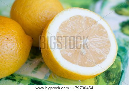 three ripe yellow lemon on the table