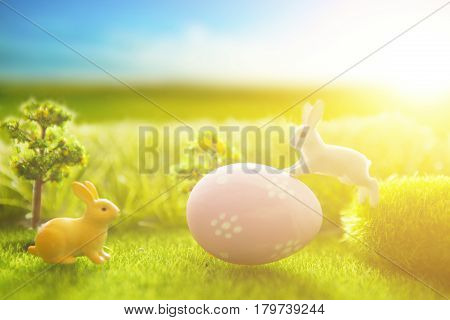 Little Easter Bunny And Easter Eggs On Green Grass Over Sunset. Macro.