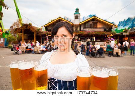 young german woman serving beer at festival