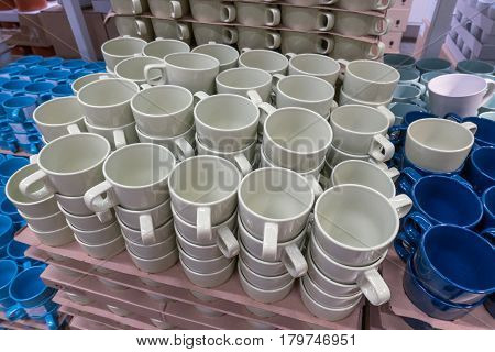 A Lot Of White And Blue Cups In The Store