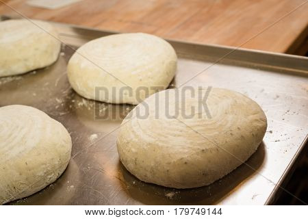 Making Round Bread On Baking Tray. Dough On Baking Tray