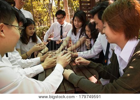 Bangkok, Thailand - November 17, 2015 : 
King Mongkut's Institute of Technology Ladkrabang is a research and educational institution in Thailand.
A group of student have fun talking and playing in the garden.