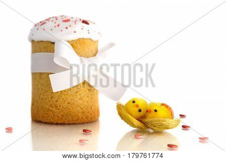 Traditional Easter cake with two yellow chicks and white ribbon isolated on white background