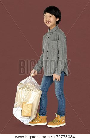 Little Boy Holding Separate Papers Studio Portrait