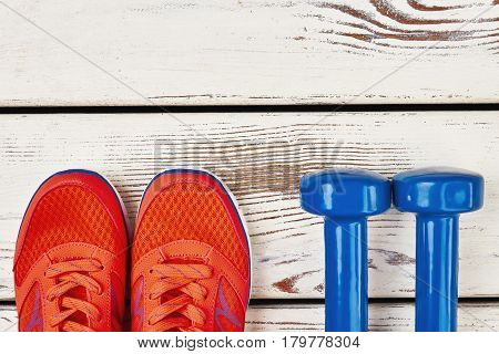 Women's sneakers and dumbbells. Time to get healthier.