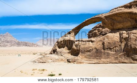 Car Near Sandstone Rock In Wadi Rum Desert