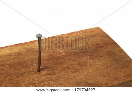 nail of metal nailed to a wooden board