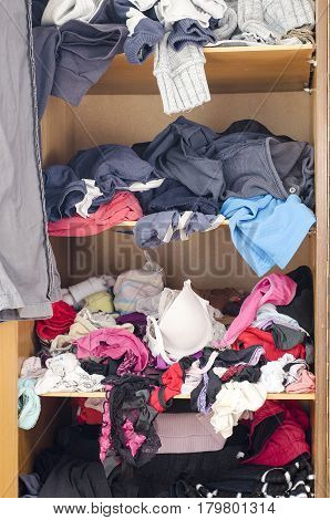 Pile Of Carelessly Scattered Clothes In Wardrobe