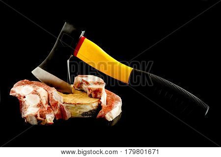 meat axe on a wooden deck on black background.